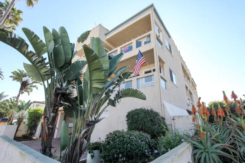 The apartment in the Ebony Pearl hangered with country flag and has plants and flowers aside of the apartment