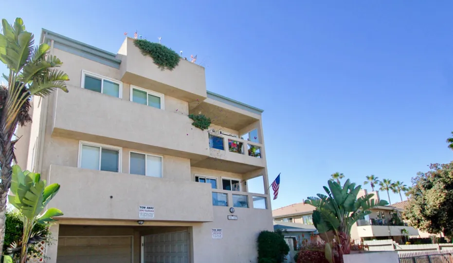 Three story housing near palm trees at Ebony Pearl in Imperial Beach California