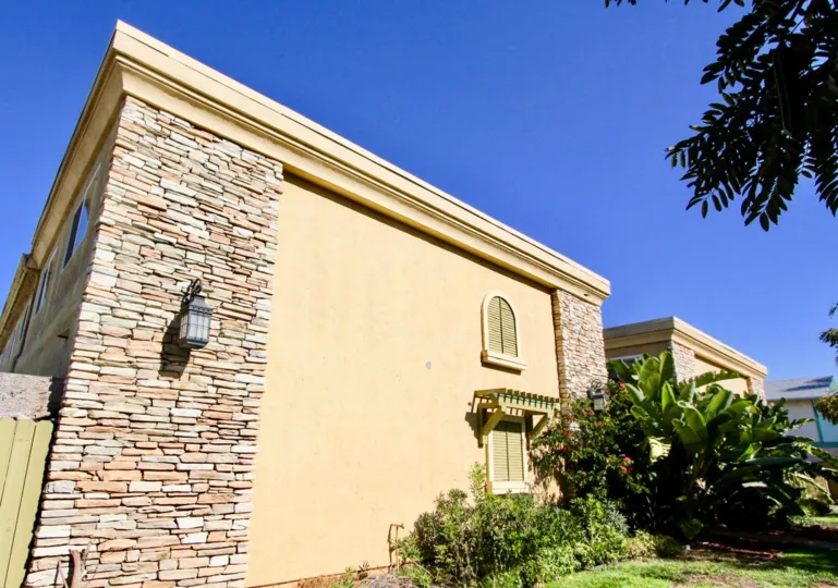A sunny day in Holly Avenue Condos has villa with Lamb and bushes