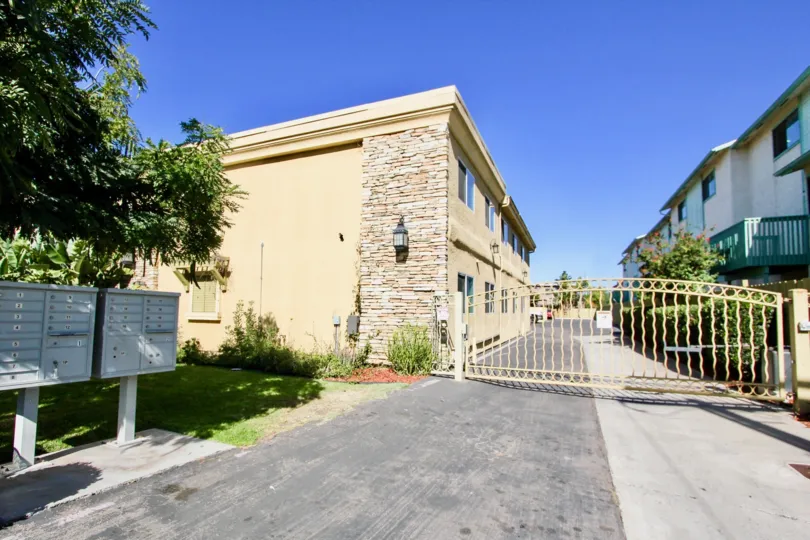 Outer view of the building in Holly Avenue Condos with street view of entrance and buildings