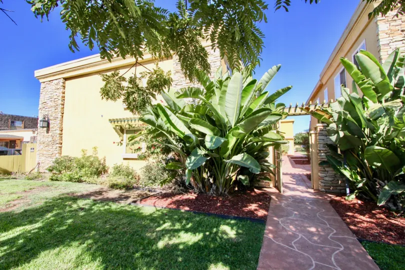 Walkway with plants & grass at Holly Avenue Condos in Imperial Beach CA