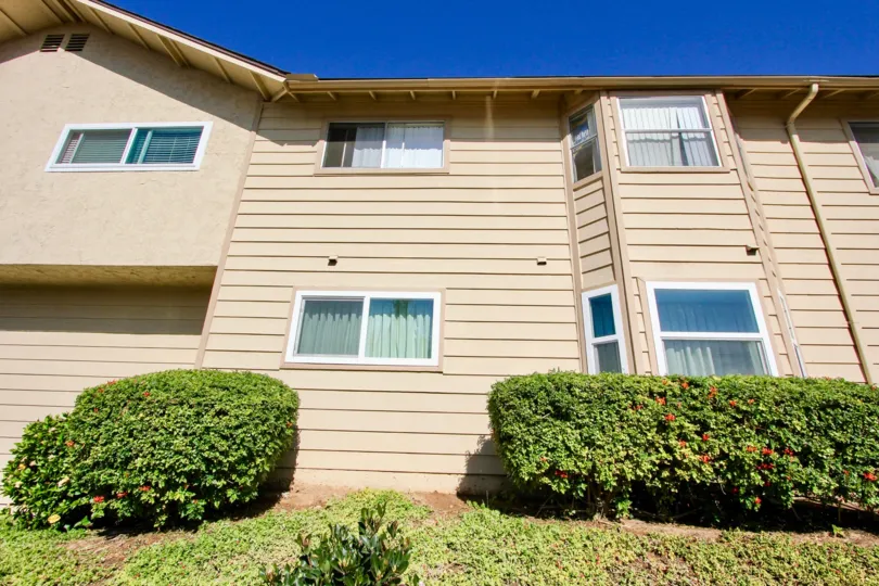 The front of a home with two floors of bay windows located in Holly Manor community.