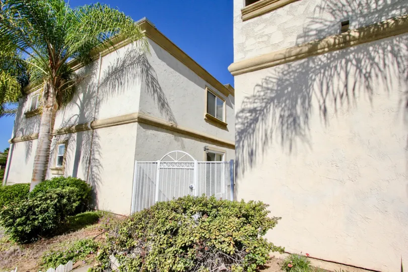 White gate between residences at Imperial Palms in Imperial Beach California