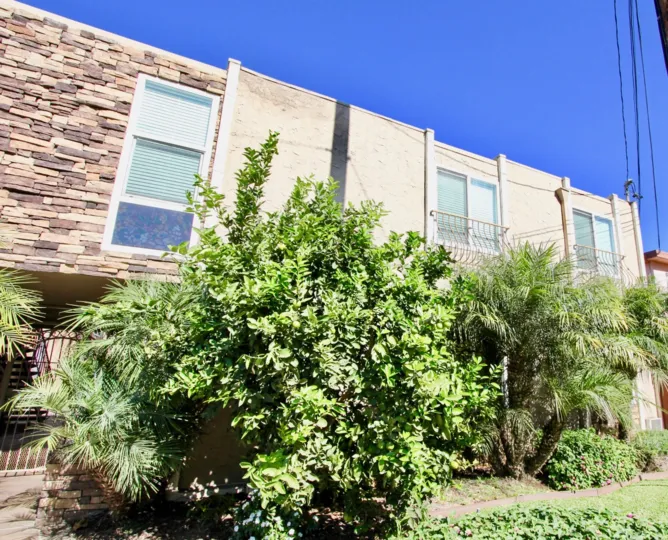 A series of buildings in Iris Gardens with landscaping on a sunny day