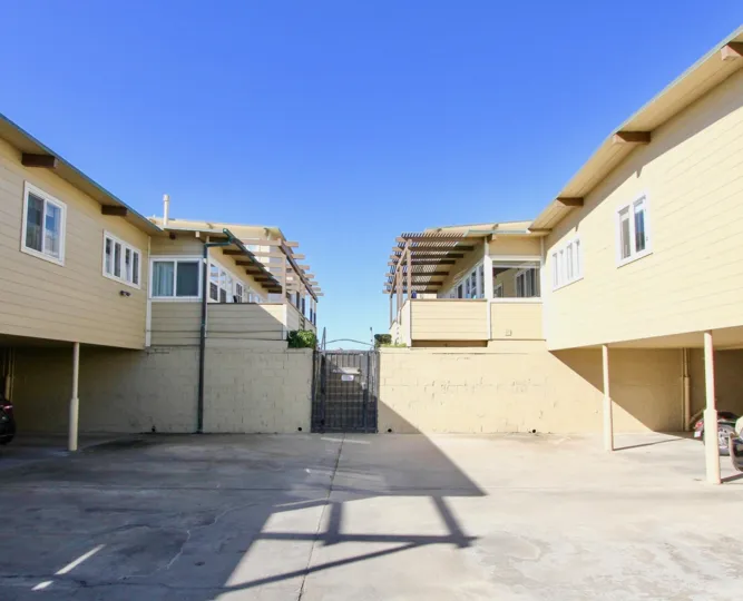 Residential units with black iron security gate at La Boca Rio in Imperial Beach California