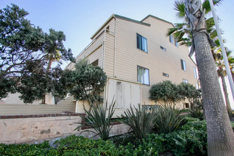 Four story residence with trees inside Ocean Palms in Imperial Beach California