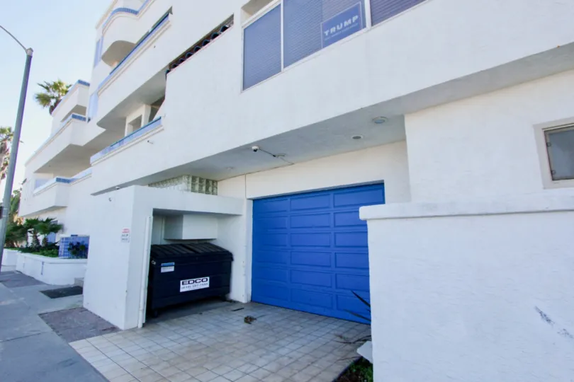 Blue garage near dumpster at Ocean Point in Imperial Beach California