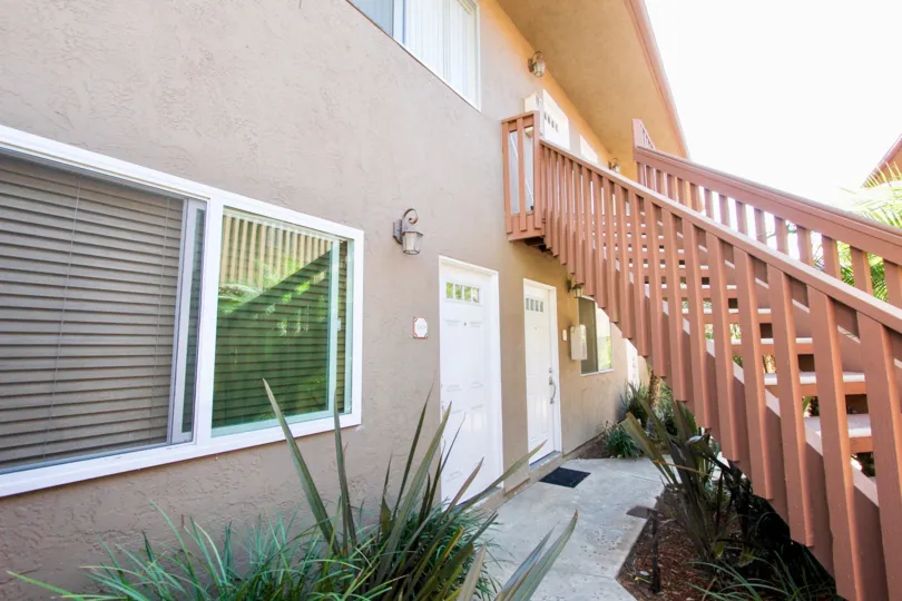 2 floors of an apartment complex, with a set of stairs going to the 2nd floor