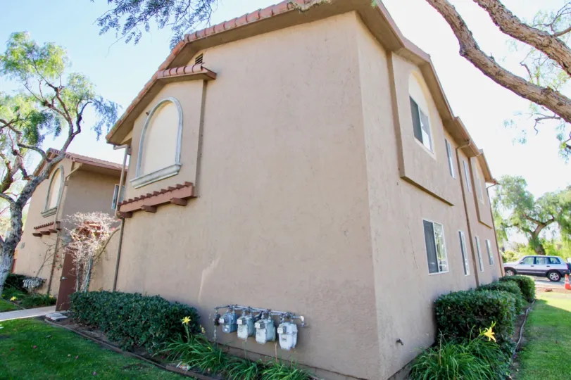 Outside of a two story home with windows and nice lawn On Donax