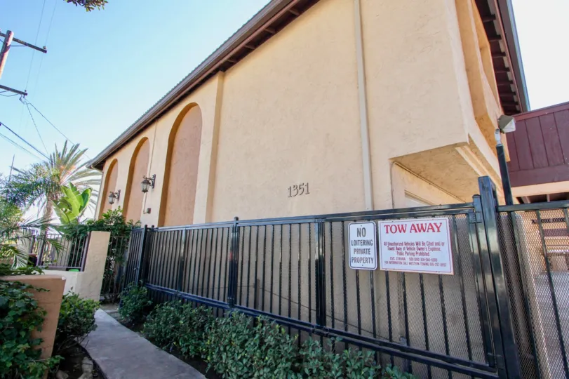 Apartment building behind iron gate at On Holly in Imperial Beach California