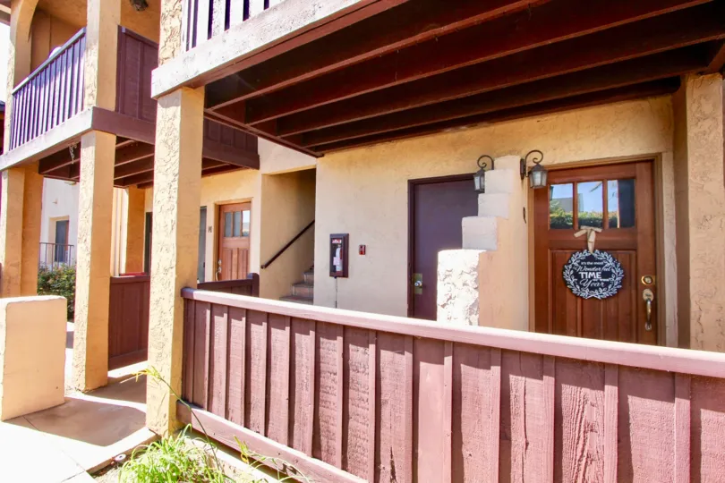 Two story housing with wooden balcony at Oh Holly in Imperial Beach California