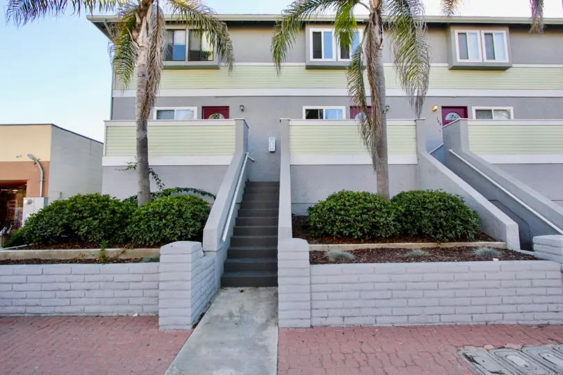 Three story housing with stairway and trees at Palm Plaza in Imperial Beach California