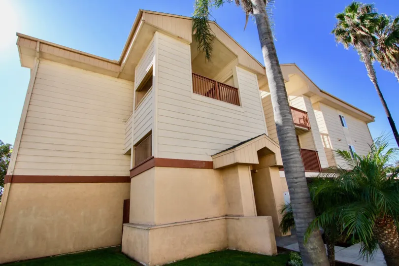 Three story residential building near palm trees at Playa Dahlia in Imperial California