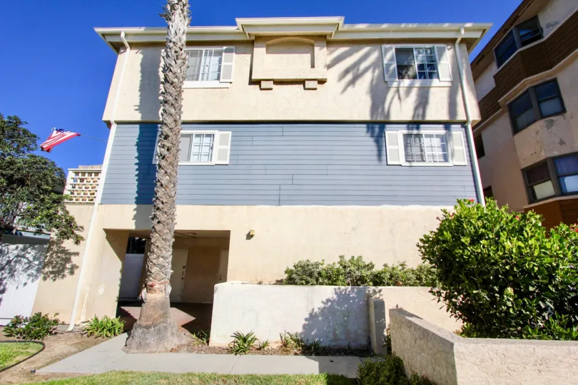 Two level home blue and tan in playa Date community.