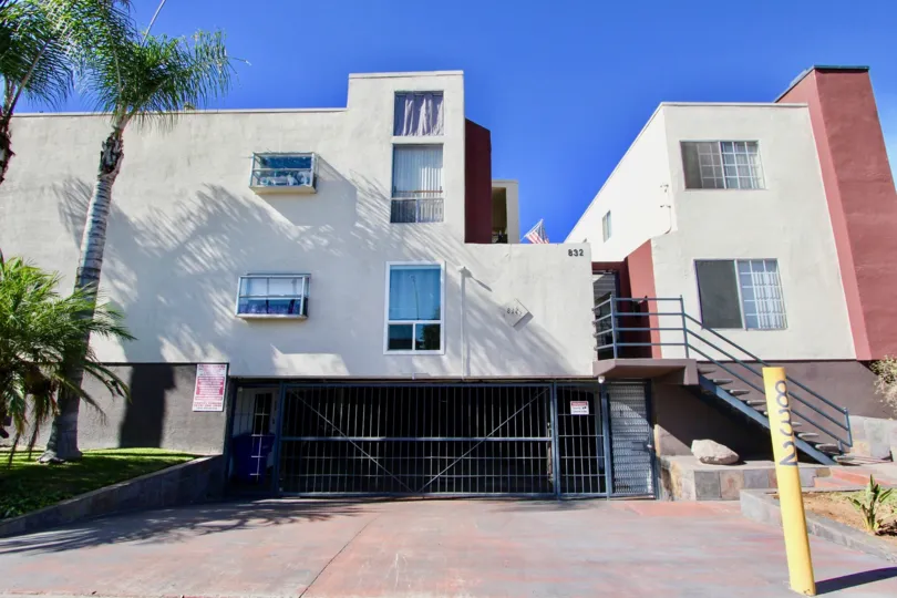 A sunny day in Riviera Beach & Bay Villas has villa with number 832 and trees