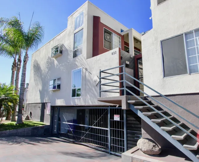A sunny day in Riviera Beach & Bay Villas has villa with number 832 and trees