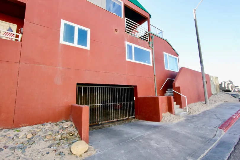 Large pink building with parking structure at Sandcastle Cove in Imperial Beach Califlrnia