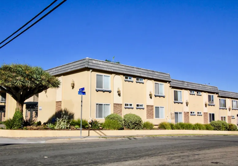 On sunny day, Sands Pointe with street board and tree, apartment