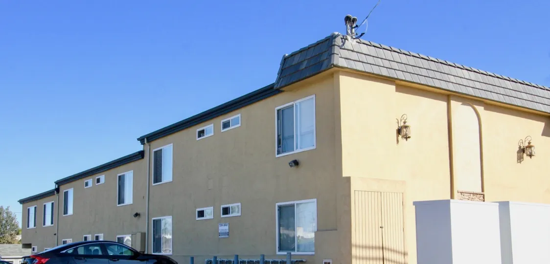 Two story apartment complex with parking at Sands Pointe in Imperial Beach CA