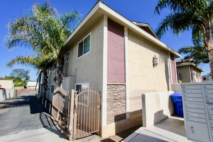 A residence in a warm climate with palm trees in the community Seabreeze Gardens.