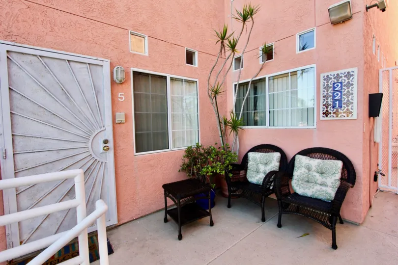 Pink apartment patio in Seaside Villas with chairs