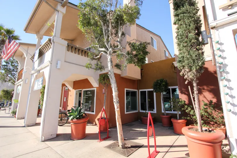 Two story residential building with windows at Shopkeeper at the Beach in Imperial Beach California