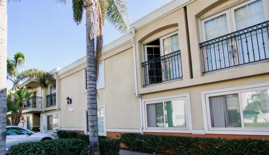 A sunny day in South Coronado Shores has villa with trees, car parking and bushes