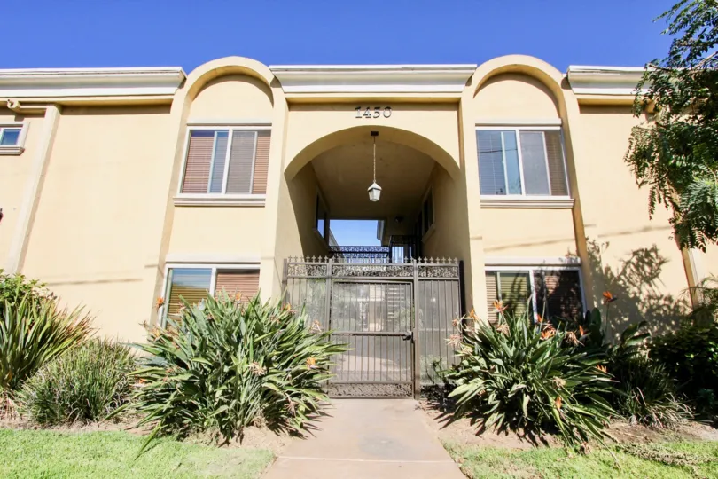 A home that has a large arch entrance blocked by a fence in Tapestry community.