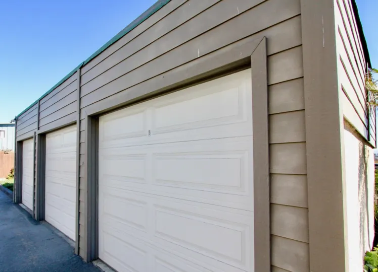 Beige building with three separate garages in Vista Del Coronado, Imperial Beach, California.
