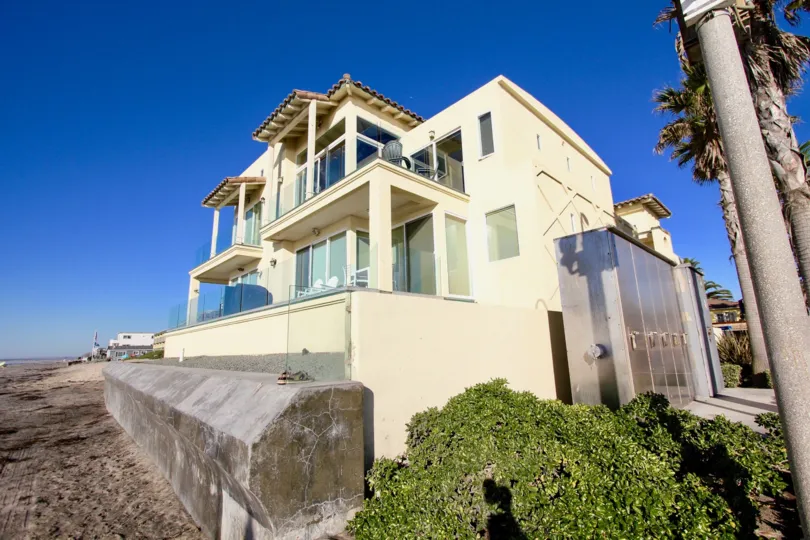 Modern three story yellow house on the beach in Wavecrest, Imperial Beach, California.