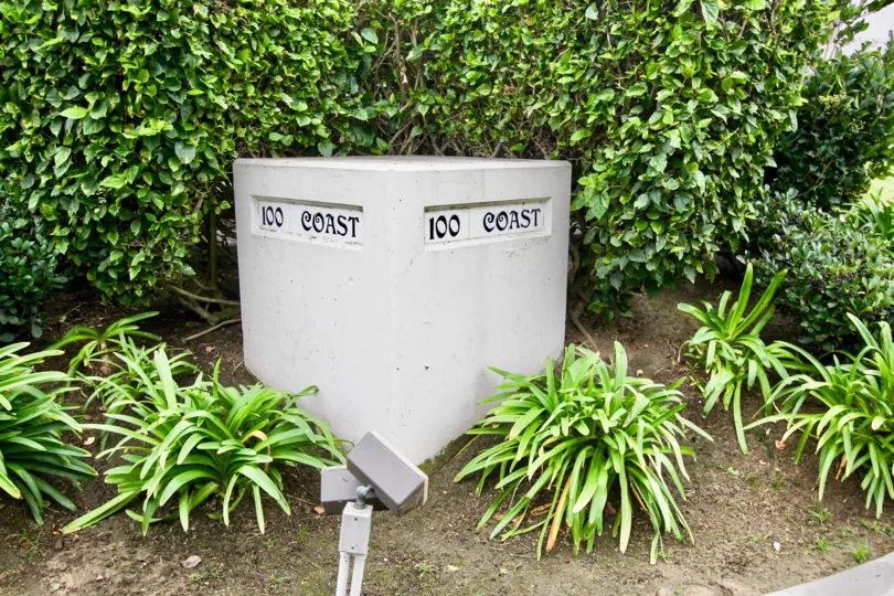 Large gray box with plants behind and around it at 100 Coast in La Jolla CA