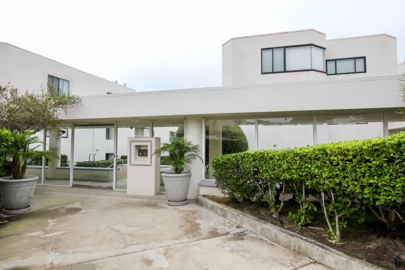 Apartment in 100 coast has plant and flower port on both sides of the path way
