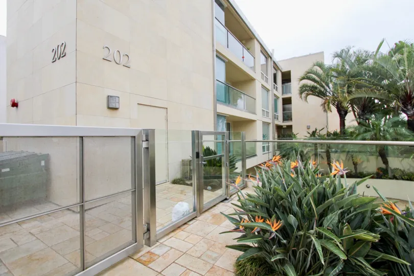 Three story building with numbers on it's front at 202 Coast in La Jolla California