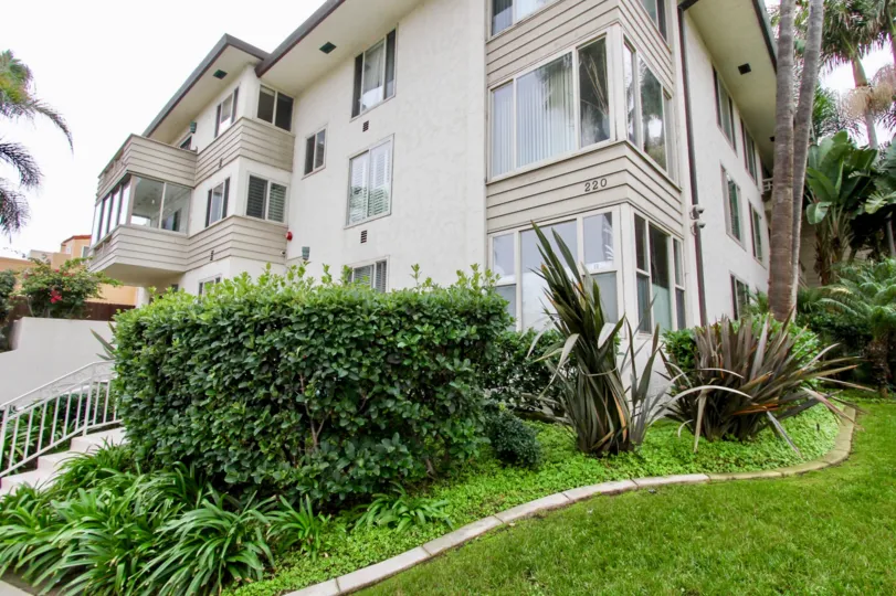 A large residential building with large windows in 220-240 Coast community.