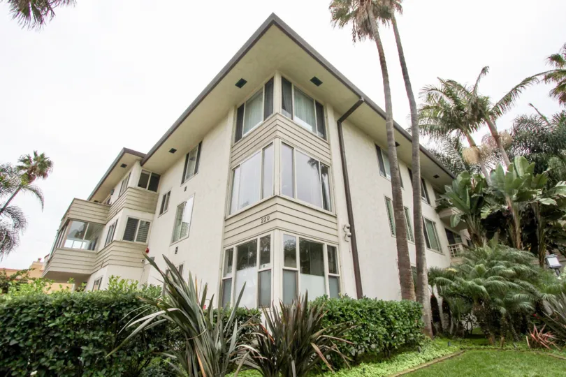 Three story residential units with trees and plants at 220-240 Coast in La Jolla CA