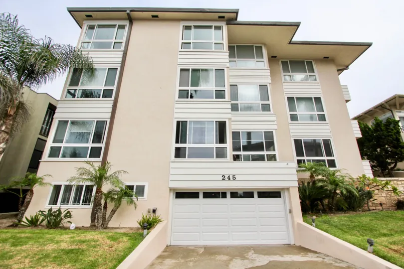 The apartment of 245 coast in La jolla city has grass and plants aside of the parkway