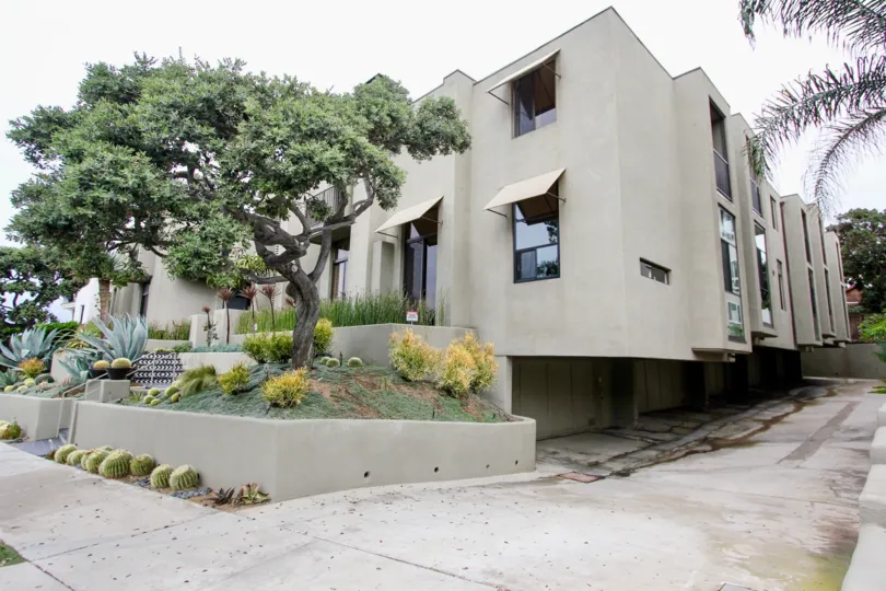A large building with rain shutters over each window at 265 Coast community.