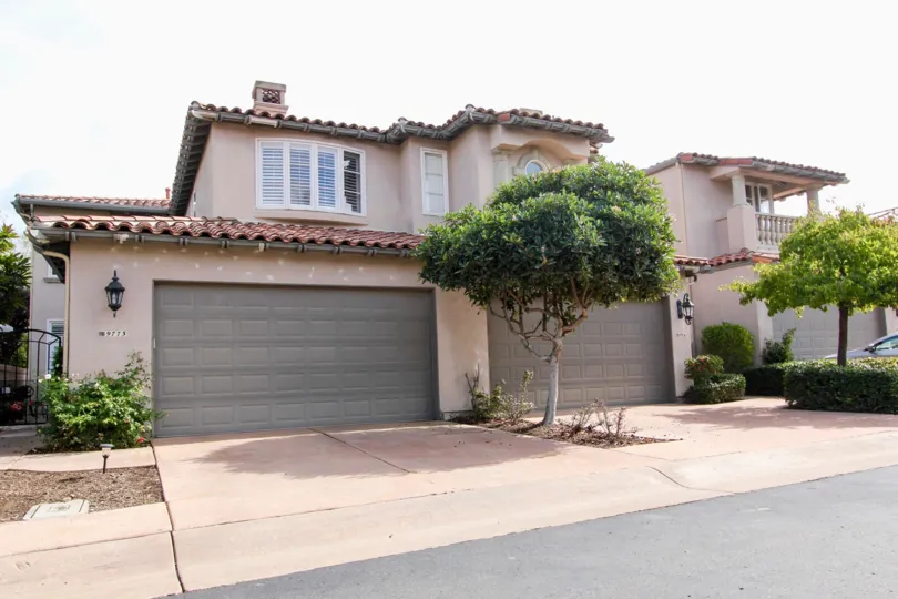 Two gray garage doors next to trees at Blackhorse in La Jolla California