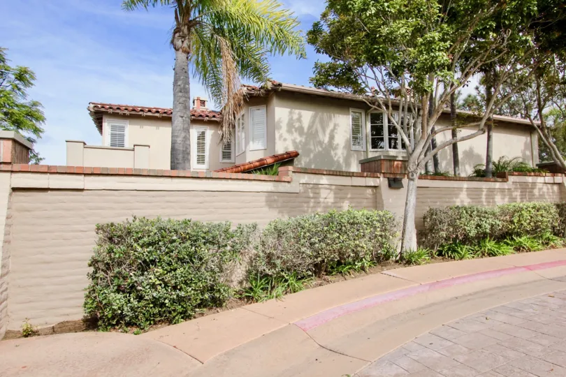 Two story residential units with wall and palm trees at Blackhorse La Jolla California