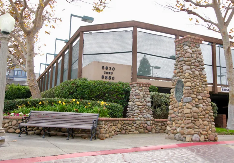Tall stone pillar with plaque outside the Boardwalk in La Jolla California
