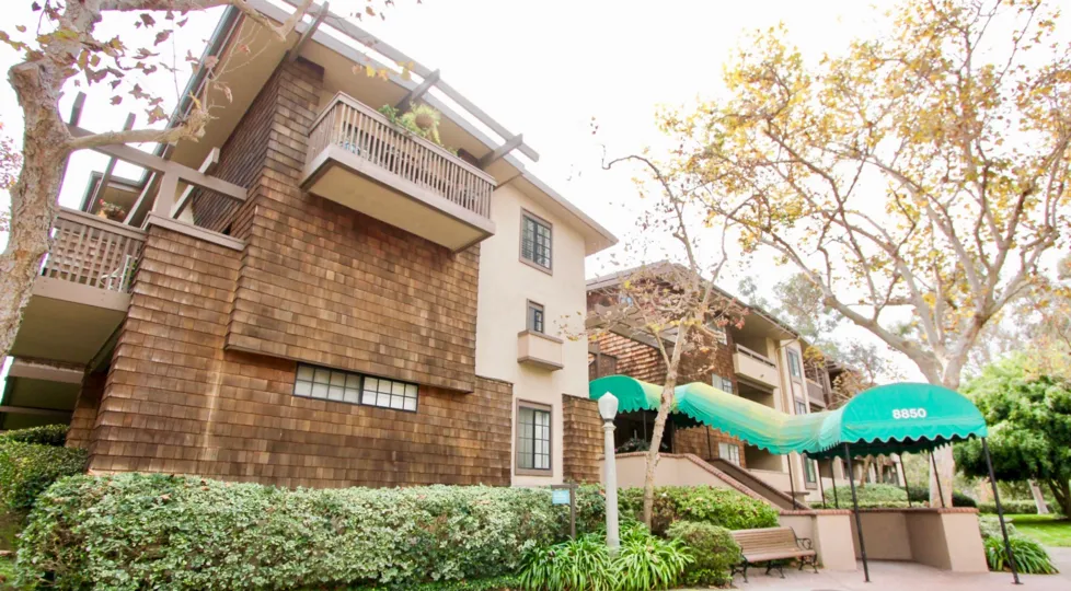 A apartment building with a green onning leading to entrance in the Boardwalk community.