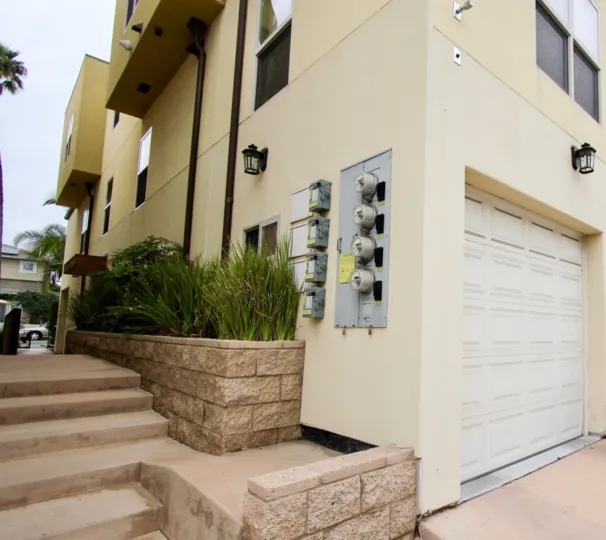 Garage and electrical meters on side of Bonair Street Condos in La Jolla, California.