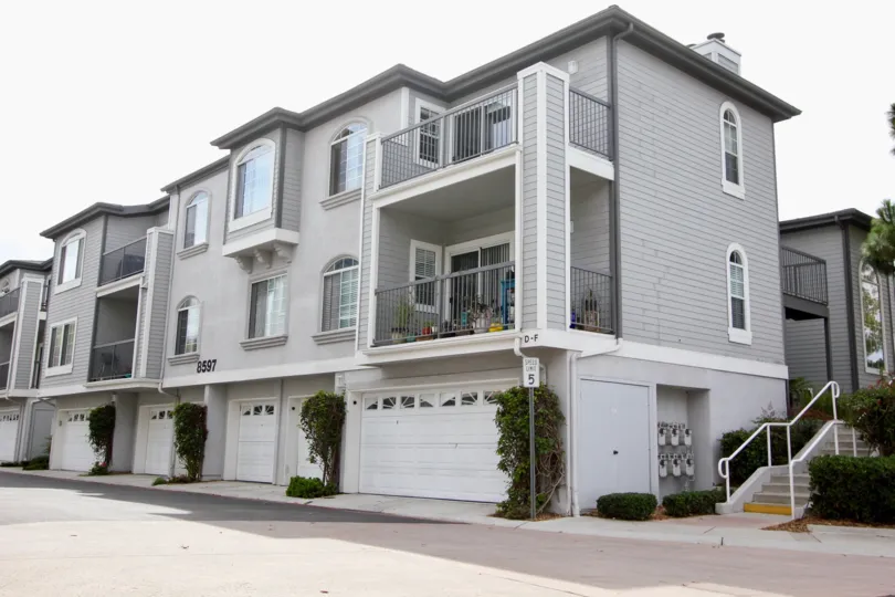 The apartments in Cape le Jolla Gardens has number with 8597 and has street lamp and bushes