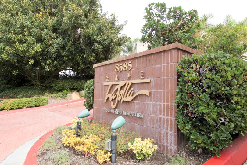 Red brick sign with gold writing at the Cape La Jolla in La Jolla CA