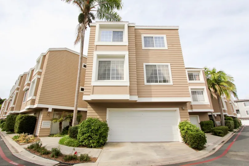 Two story brown building with white garage door inside Cape La Jolla at La Jolla California