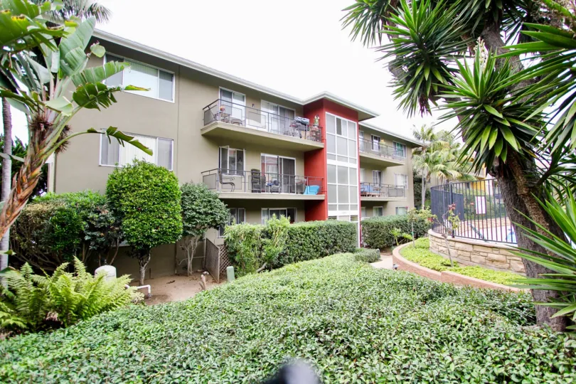 The apartments in Capri Aire is cover with bushes plants and trees