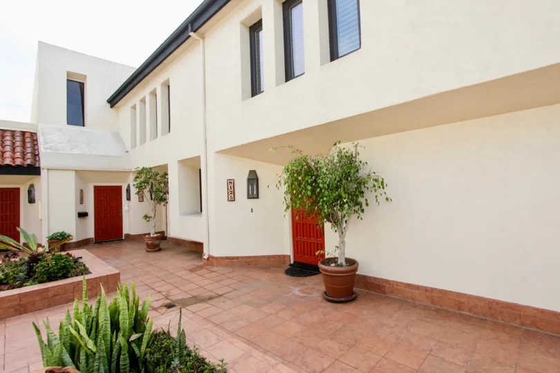 An adobe home with a potted tree in Casa Del Grande