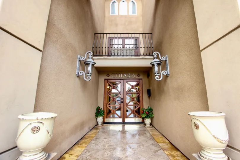 At the entrance of Chiara, Has two flower pots and light lamps attached on the wall on both sides