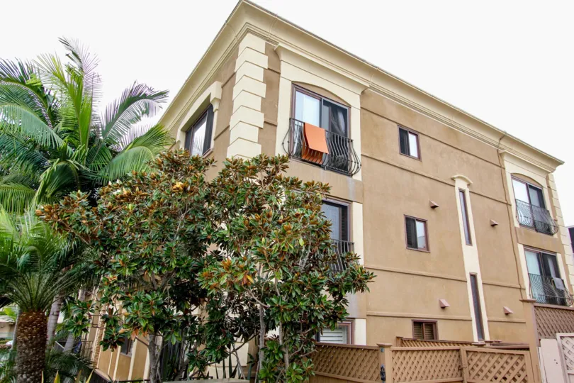 Three brown residential building with black railing at Chiara in La Jolla CA