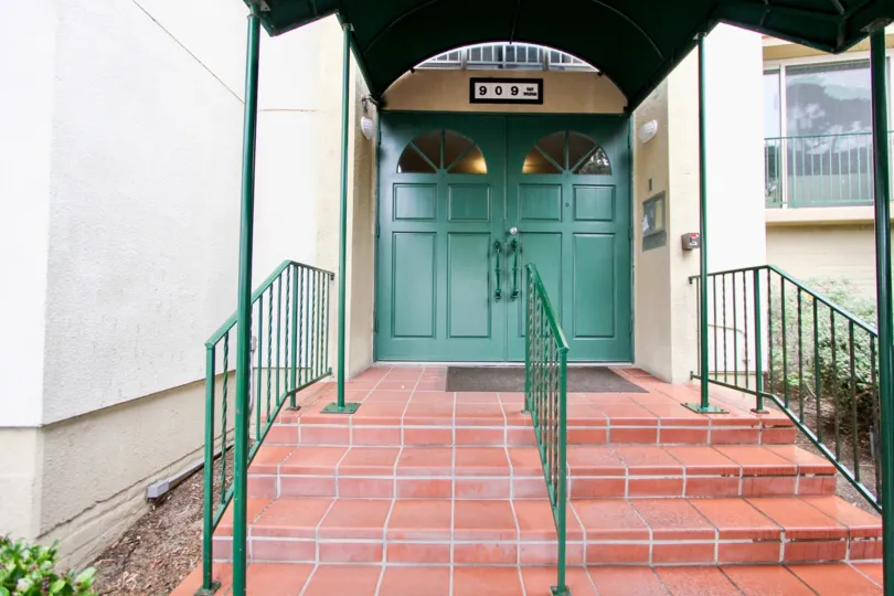 Green doors at black canopy at Coast Regency in La Jolla CA